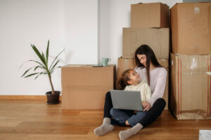 is it better to rent or buy a house, mom and daughter with moving boxes