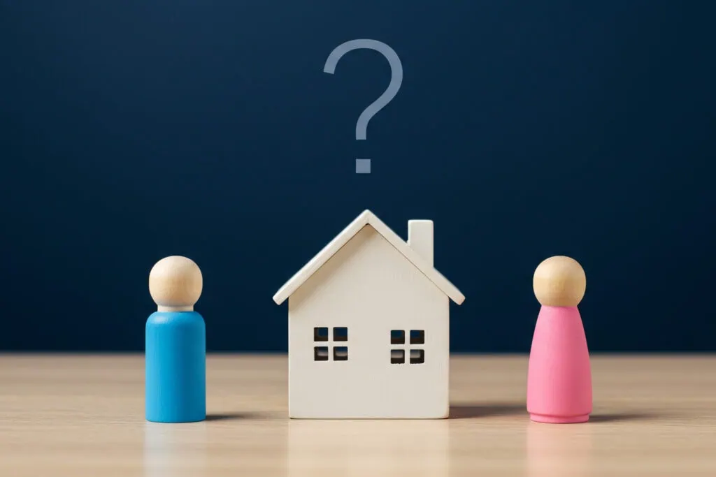 Real Estate divorce, house with wooden male and female figures with question above mark